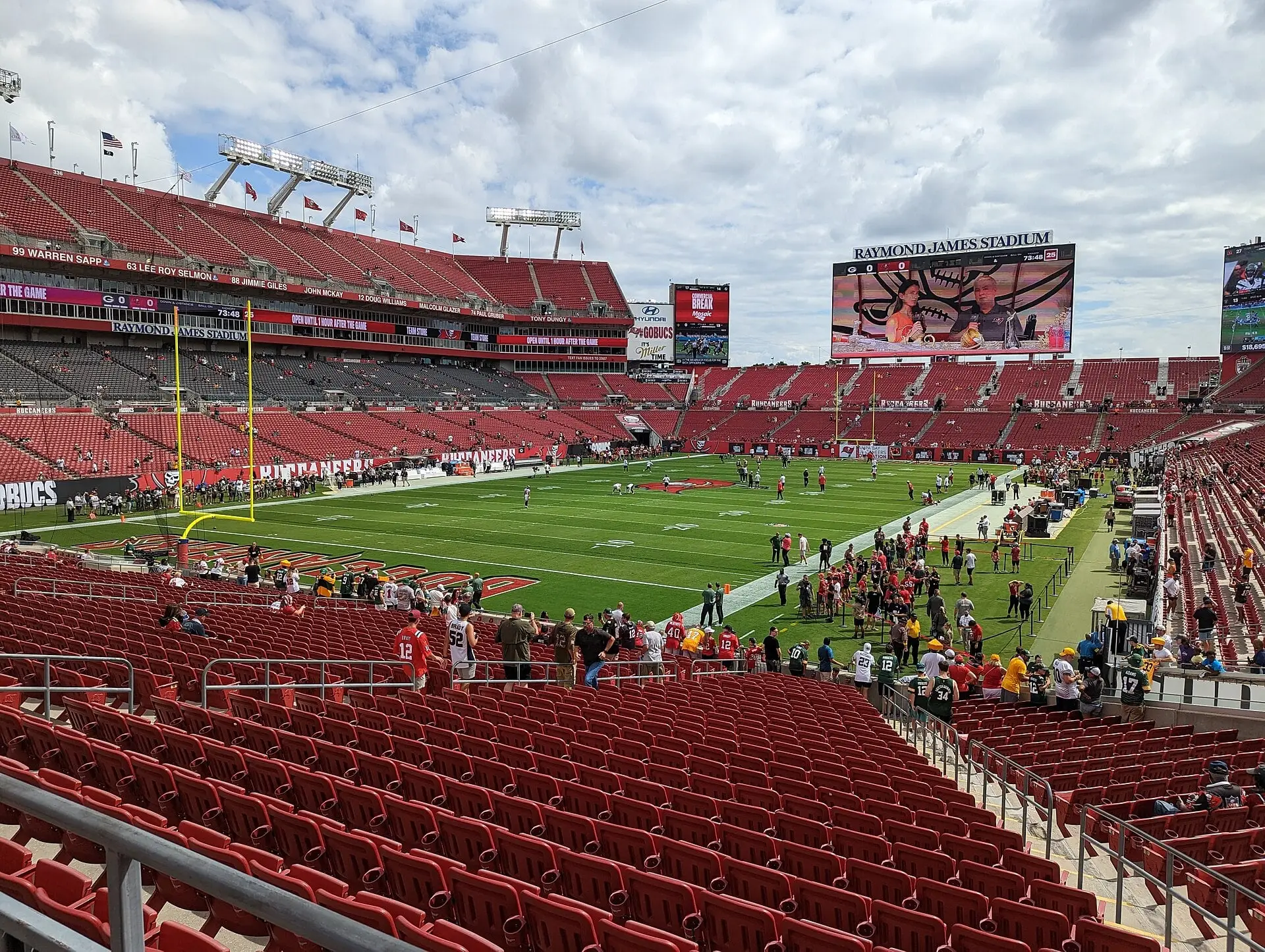 Raymond James Stadium in Tampa seen from across the field corner, with the south end zone scoreboard and Krewe's Nest seating expansion, September 2022