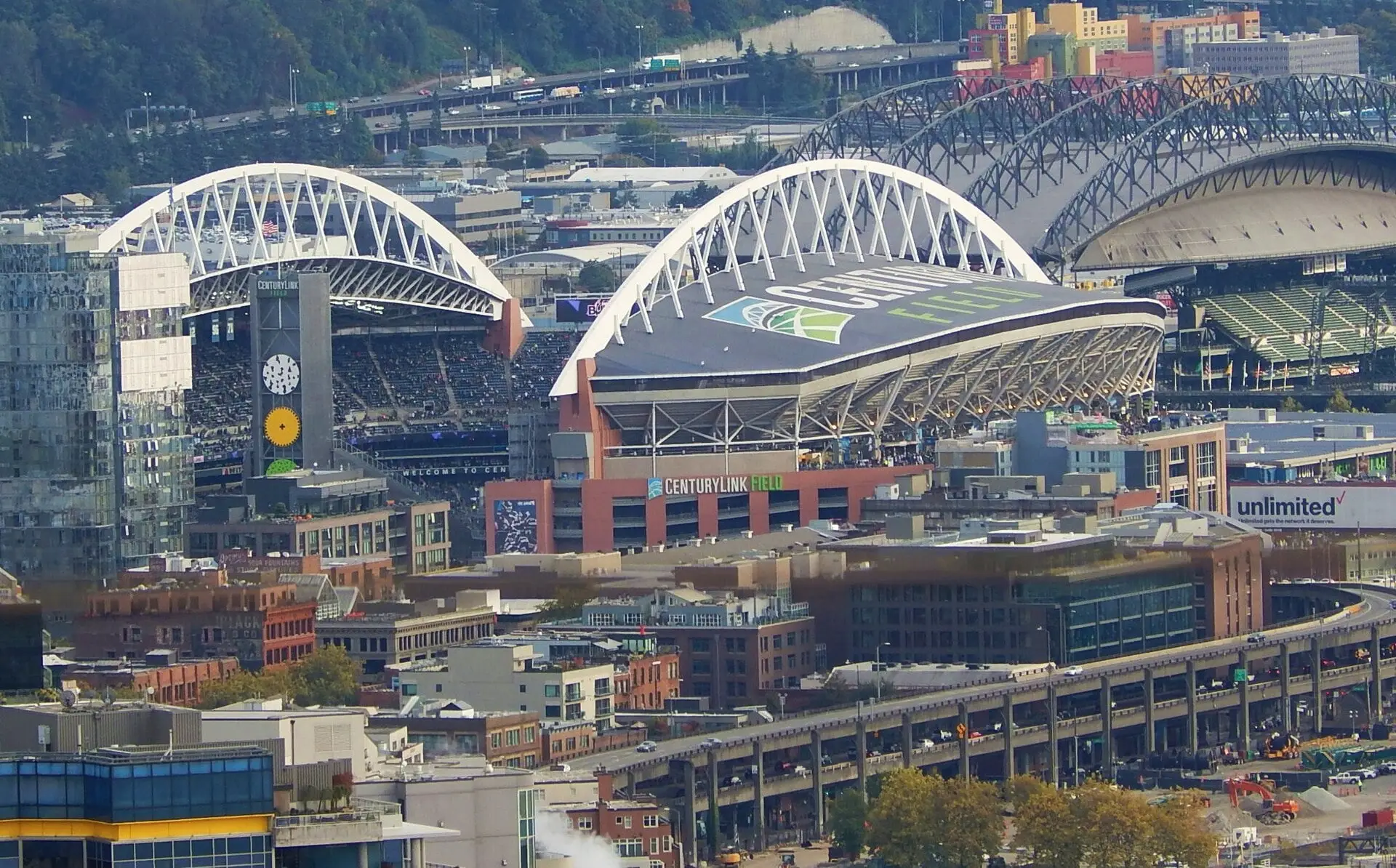 Lumen Field from the Space Needle with a pregame crowd outside, annotated with nearby landmarks