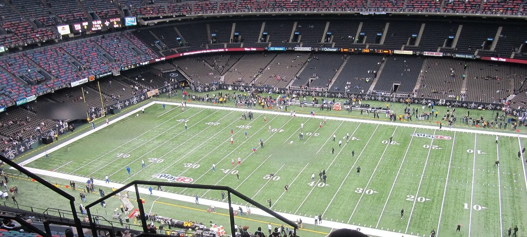 High view from the upper level of the Superdome looking down the length of the field during Saints pregame, with the fleur-de-lis at midfield and both sides of the bowl visible